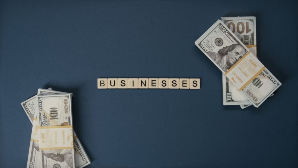 pexels-photo-5912592-5912592 Top view of dollar bills and 'businesses' letter tiles symbolizing financial success.